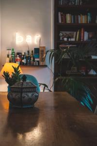 a vase sitting on a wooden table with a plant at Vaticano/Trastevere Floreal Suite in Rome