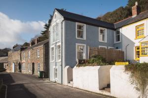 a gray and white house on the side of a street at Blue Horizon in Portloe