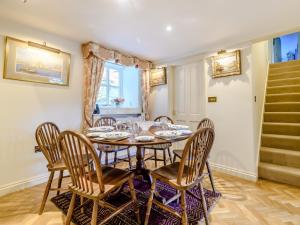 a dining room with a table and six chairs at 3 Bed in Presteigne 78336 in Evenjobb