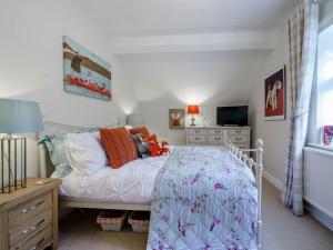 a bedroom with a bed and a dresser and a television at 2 Bed in Grange Over Sands 78871 in Grange Over Sands