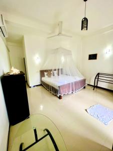 um quarto com uma cama e uma rede mosquiteira em Leen Tangalle em Tangalle