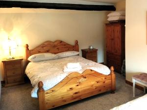 a bedroom with a wooden bed and two night stands at 2 Bed in Bwlch BN138 in Bwlch