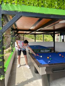 a man is playing pool on a pool table at El piedron in Bogotá