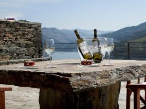 a table with wine bottles and glasses on it at Quinta Da Marka in Covas do Douro +36 photos