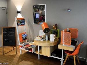 a room with a desk and a table with a chair at ibis Styles Gien in Gien