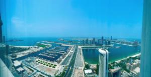 an aerial view of a city with a harbor at 54 Floor Palm & Sea View Dubai Marina. LUX / NEW in Dubai