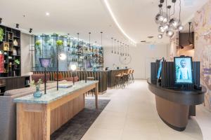 a restaurant with a table in the middle of a room at GHOTEL hotel & living Würzburg in Würzburg