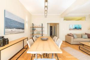 a living room with a table and a couch at Syntagma H&B Apartment in Athens