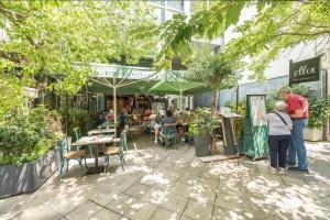 a group of people standing outside of a restaurant at Syntagma H&B Apartment in Athens