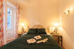 a bedroom with a green bed with two towels on it at VOLTI ON THE BAY AP4386 By Riviera Holiday Homes in Villefranche-sur-Mer