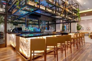 a bar in a restaurant with a bunch of chairs at Home2 Suites By Hilton Anaheim Resort in Anaheim