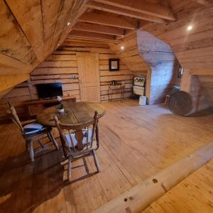 a room with a table and a chair in a cabin at La Maison En Bois 