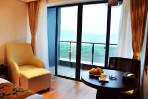 a hotel room with a table with fruit on it at Wyndham Garden Lingshui in Lingshui