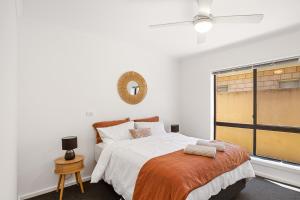 a bedroom with a bed and a window at Waterfront Villa Provence in Port Lincoln