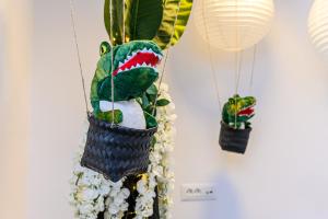 a stuffed animal in a basket hanging from a plant at Jungle Family Villa near Park Aventura,Lake,Zoo in Braşov