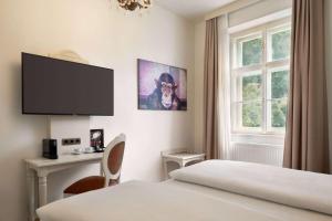 Telewizja i/lub zestaw kina domowego w obiekcie Amedia Plaza Wels, Trademark Collection by Wyndham