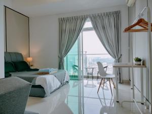 a bedroom with a bed and a large window at Delight Homestay Twin Galaxy Studio Room in Johor Bahru