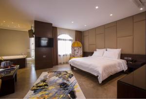 a bedroom with a large bed and a bathroom at Opera Hotel 