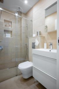 a bathroom with a toilet and a sink and a shower at Modern 2BD Flat with Prime Location and Workspace in Sofia