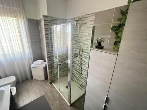 a bathroom with a shower and a toilet at Grace's House - Milan & Rho Fiera in Vittuone +17 photos