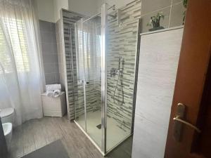 a bathroom with a glass shower with a toilet at Grace's House - Milan & Rho Fiera in Vittuone