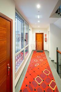 a hallway with a red carpet in a store at El Balcón De Magdalena in Oviedo