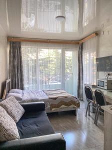 a bedroom with a bed and a desk at уютная студия Maksim in Batumi