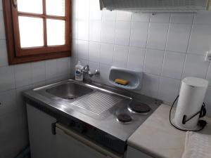 a kitchen counter with a sink and a window at Dimi's studio in Skala Kallonis