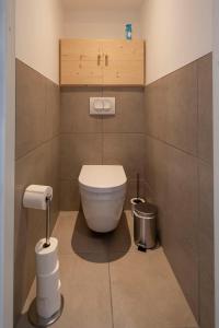 a bathroom with a white toilet in a room at La Niche 2 in Brides-les-Bains