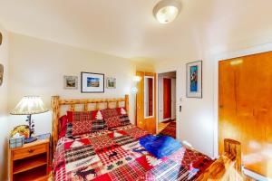 Un dormitorio con una cama con un edredón rojo. en Wallowa Lake Inn, Whole Home, en Joseph
