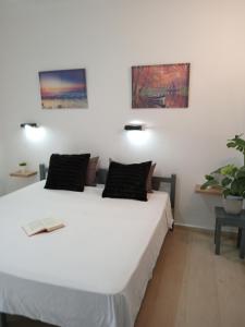 a bedroom with a large white bed with two pillows at Rose apartment nr1 Mesongi in Mesongi +26 photos
