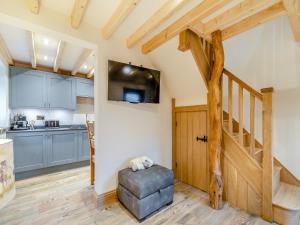 a kitchen and living room with a wooden door at Little Pythorn - Uk45253 in Westerdale