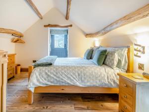 a bedroom with a large bed and wooden floors at Little Pythorn - Uk45253 in Westerdale