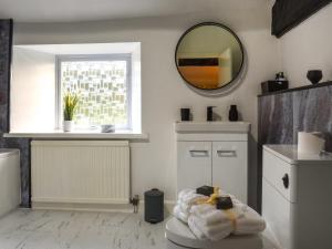 a bathroom with a mirror and towels on a table at The Greenwoods in Barrowford