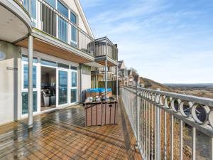 a balcony with a view of the ocean at Milkwood in Pendine