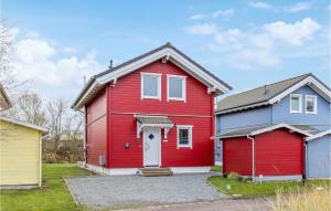 ein rotes Haus mit einer weißen Tür in der Unterkunft Seeteufel 5 in Süssau