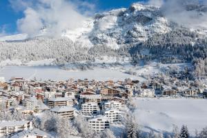 a town covered in snow with a mountain in the background at Edelweiss Ferienwohnung, Panoramablick in Flims