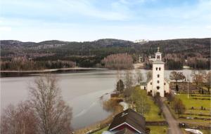 an island in the middle of a lake with a lighthouse at 2 Bedroom Stunning Home In Grsmark in Gräsmark