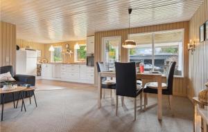a kitchen and dining room with a table and chairs at Amazing Home In Ebeltoft With Wifi in Ebeltoft