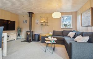 a living room with a blue couch and a fireplace at Amazing Home In Ebeltoft With Wifi in Ebeltoft