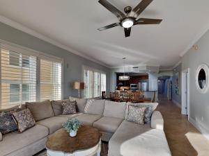 a living room with a couch and a ceiling fan at Adagio 105B in Santa Rosa Beach