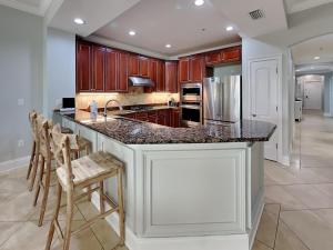 a kitchen with a large island with a counter top at Adagio 105B in Santa Rosa Beach