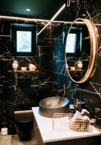 a bathroom with a sink and a mirror at ArtHouse Podhale in Klikuszowa