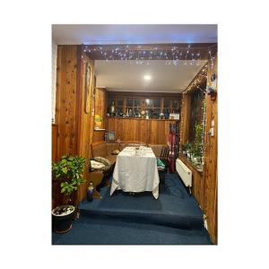 a room with a table with a white table cloth at Pensiunea Nick in Sinaia