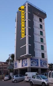 a building with a yellow sign on the side of it at G&19 Apartment in Addis Ababa