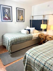 a hotel room with two beds and a lamp and pictures on the wall at 7 - Central Studio - King Bed - Bike Facilities in Merthyr Tydfil