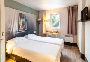 Postel nebo postele na pokoji v ubytování B&B HOTEL Limoges 1