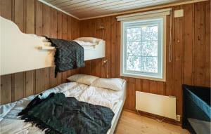 a room with two bunk beds and a window at 6 Bedroom Nice Home In Nord-torpa in Nord Torpa
