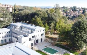 an aerial view of a white building with a swimming pool at Nice Apartment In Siena With Sauna in Siena +23 photos
