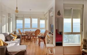 a living room with a couch and a table at Beach Front Apartment In Algarrobo-costa With Outdoor Swimming Pool in Algarrobo-Costa